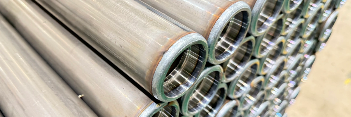 Welded bearing housing on conveyor roller showing weld seam and heat affected zone at the tube end