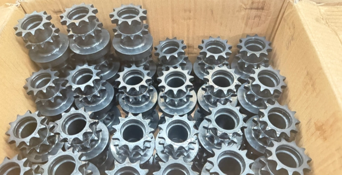 black oxide treated carbon steel sprockets prepared for welding to stainless steel conveyor roller tubes