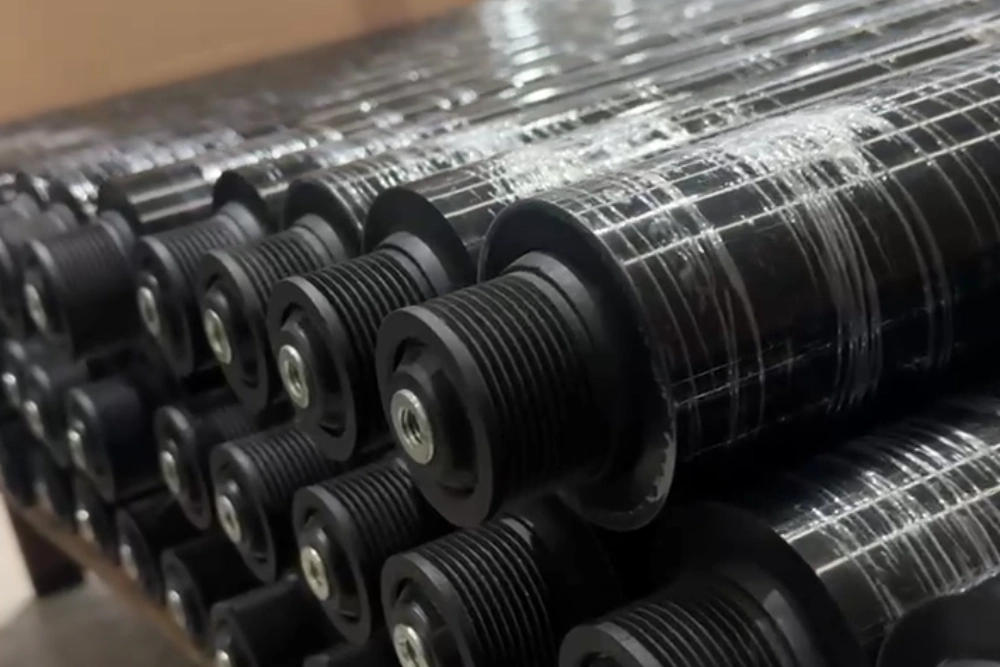 Black PU-coated poly V conveyor rollers with PJ pulleys, stacked at the LEEV factory