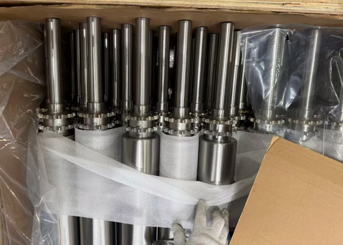 304 stainless steel live-shaft rollers with drive sprockets packed in a wooden crate