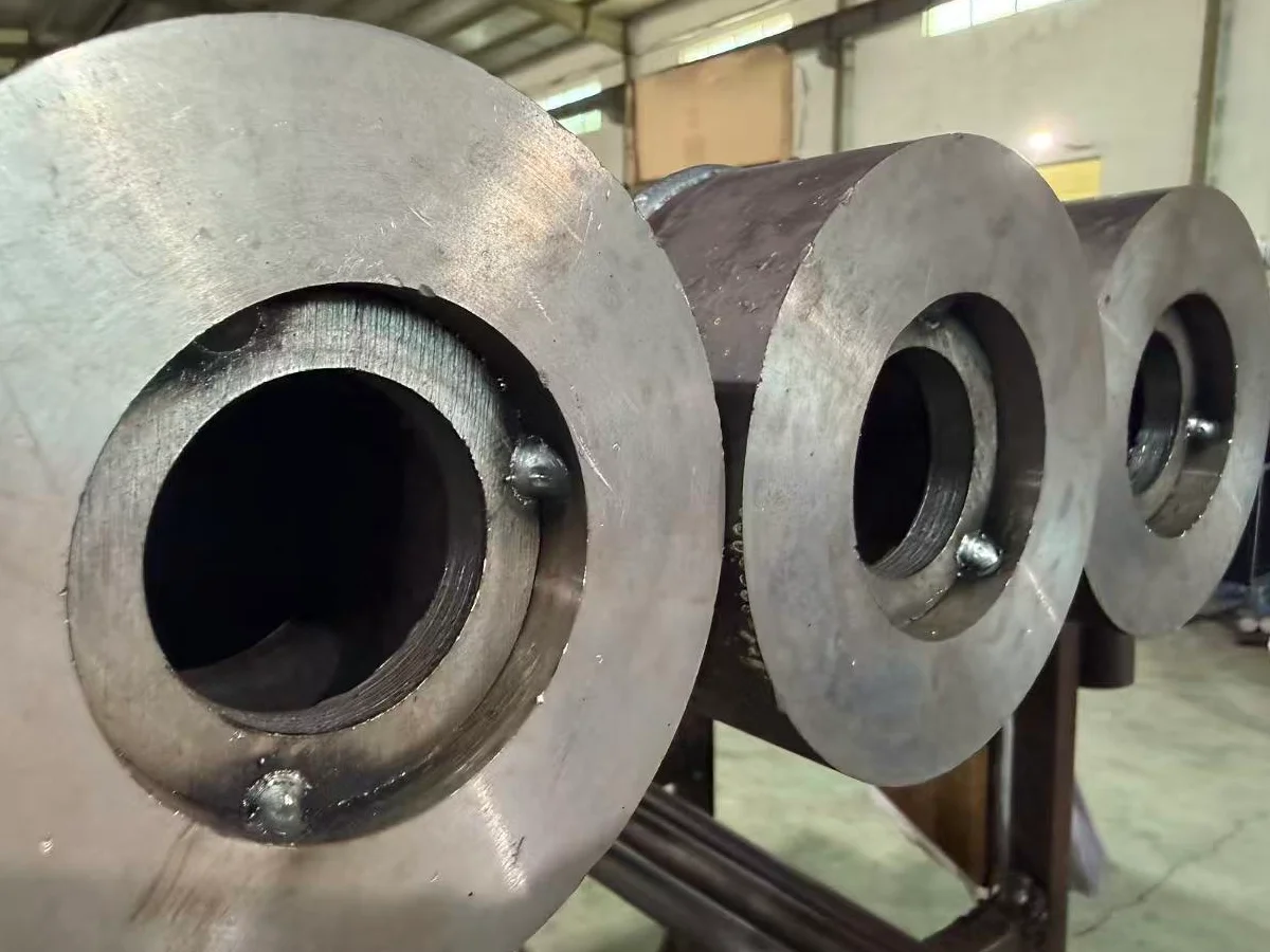 Steel roller tubes with fitted end plates prepared for live-shaft assembly
